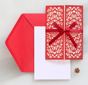 Red laser-cut wedding card featuring a hollow Double Happiness sign and satin ribbon bow