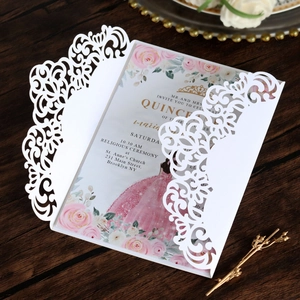 Macro detail of laser-cut lace invitation with elegant floral and ribbon textures