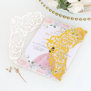 Detail of laser-cut glitter invitation with floral insert and intricate lace design