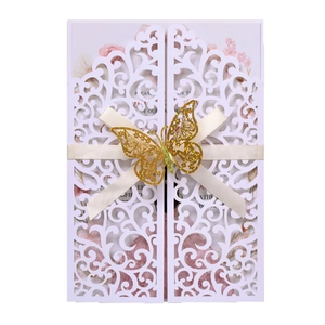Laser cut wedding invitation with white hollow cardstock, beige bow and gold butterfly