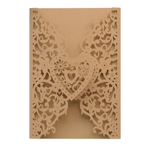 Laser-cut champagne gold wedding invitation envelope with intricate heart and floral patterns