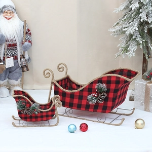 Detail of red buffalo plaid Christmas sleigh baskets with pine cones and needles