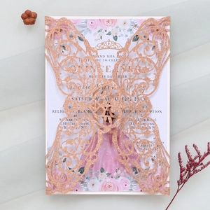 Detail of rose gold glitter laser-cut butterfly invitation with floral insert card