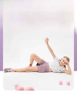 Girls activewear set featuring white T-shirt and lilac shorts with tennis ball detail