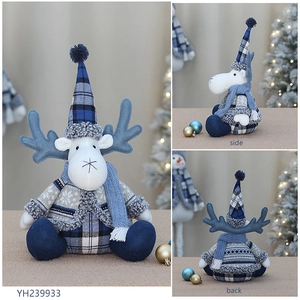 Front side and back views of blue fabric Christmas reindeer doll with knitted sweater