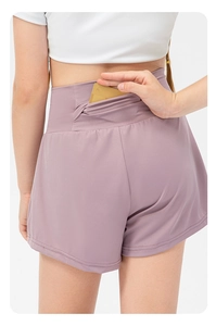 Detail showing high-waist yoga shorts with a functional hidden zipper back pocket