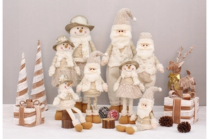 Detail of plush Christmas gnomes with gold sequins and knitted fabric texture decor