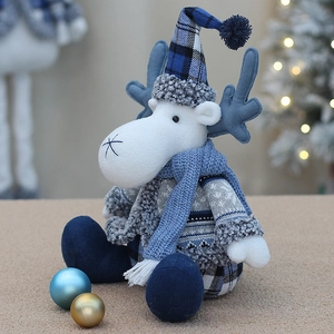 Detail of Christmas reindeer plush with blue knit hat and cozy winter textures