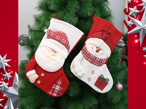 Detail of red and white knitted Christmas stockings with Santa and snowman accents