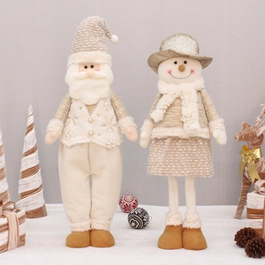 Detail of cream and gold plush Christmas gnomes with knit textures and sparkle finish