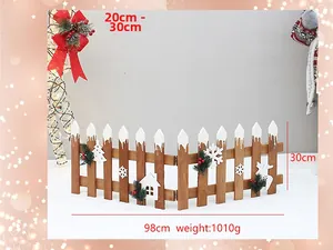 Close-up of a 30cm dark wood Christmas tree fence with faux snow and red berries