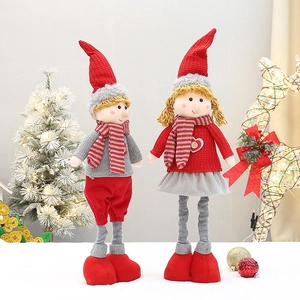 Detailed view of handmade Christmas plush dolls with red and grey knitted fabric outfits