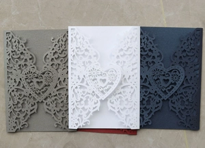 Laser cut wedding invitation covers with heart and floral patterns in multiple colors