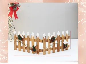 Detail view of 30cm high wooden Christmas fence with white snow caps and small cabins