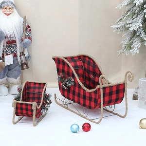 Christmas buffalo plaid sled decor with pine cones and berries in a festive setting