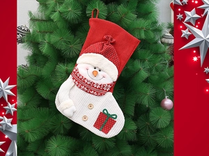 Detail of red and white knitted Christmas stocking with 3D snowman hanging on tree