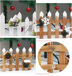 Detail of wooden Christmas tree fence with pine cones, red berries and metal hinges