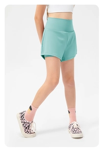 Detail view of mint green girls' loose running shorts with high waist and 2-in-1 design