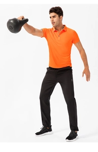 Detail of breathable mesh fabric on orange men's athletic polo shirt for fitness training
