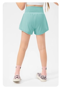 Detail view of mint green high-waisted running shorts with supportive back stitching