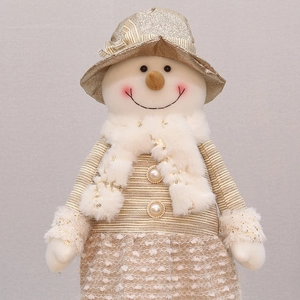 Detailed close-up of snowman doll with champagne gold sequins and pearl button accents