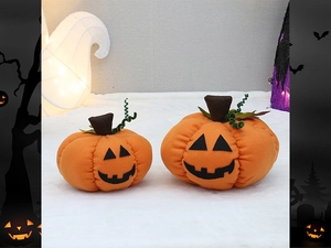 Detail of plush orange Halloween pumpkins with black Jack-o'-lantern faces for party decor