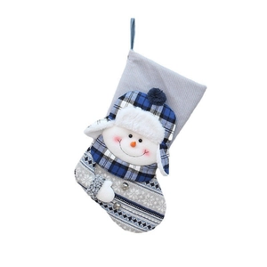 Blue knitted Christmas stocking with plush snowman decoration and festive silver bells