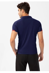 Detail of dark blue men's polo shirt showing navy honeycomb breathable fabric and red sleeve trim
