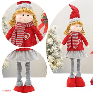 Detail of Christmas girl doll with red heart-button sweater and gray pleated skirt