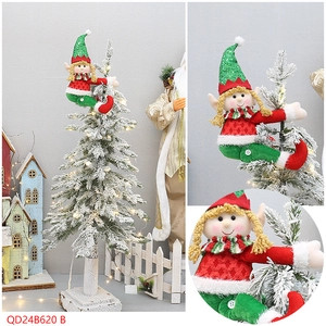 Macro view of plush Christmas elf hanging doll with green sequin hat on a tree
