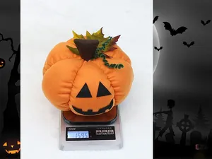 Detailed view of a 9-inch Halloween plush pumpkin weighing 159.5g on a scale