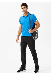 Detail of blue men's sport polo shirt with neon trim and black athletic pants