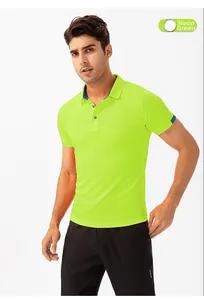 Detail of fluorescent green sports polo shirt featuring navy blue collar trim and buttons