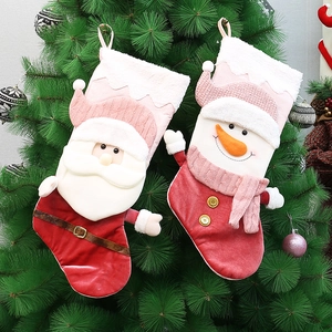 Detail of Christmas stocking ornaments with Santa and Snowman hanging on a tree