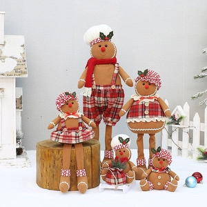 Set of five plush gingerbread man dolls with red plaid outfits on snowy display