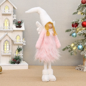 Close-up of pink and white plush Christmas angel doll with retractable legs and silver tinsel