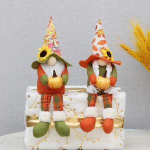 Detail of harvest gnomes with maple leaf hats and sunflowers for Thanksgiving decor