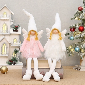 Detail of plush Christmas angel dolls with retractable legs and glittering wings on display