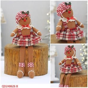 Close-up of knit gingerbread doll with red checkered hat and white lace collar detail