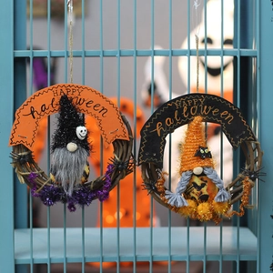 Halloween gnome grapevine wreaths with spiders and Happy Halloween banners on fence