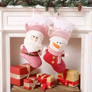Set of two festive Christmas stockings featuring Santa and Snowman over a white fireplace