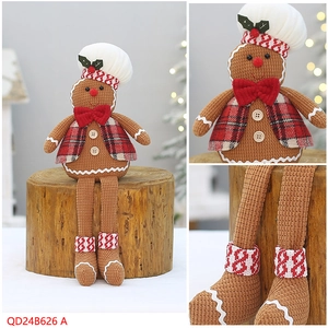 Detail of gingerbread man chef doll with white chef hat and red plaid vest for Christmas decor