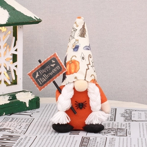 Close-up of Halloween gnome holding a Happy Halloween sign with a long pointed spider hat