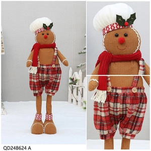 Detail of gingerbread man doll with chef hat and red scarf for Christmas decor