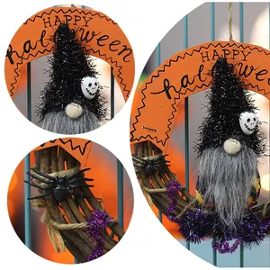 Detail of Halloween gnome wreath with natural vine base, spider and Happy Halloween sign