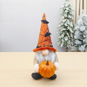 Halloween plush gnome with pumpkin, orange spider web hat and bat decor on wood surface