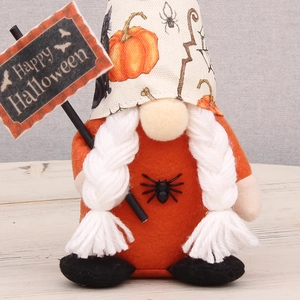 Detail of Halloween gnome with long braids, spider decor, and Happy Halloween sign