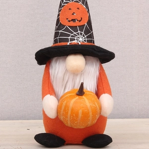 Detail of Halloween gnome plush with spider web hat and pumpkin accessory in hand