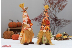 Detail of Thanksgiving gnomes with sunflower and maple leaf patterns in a cozy autumn setting