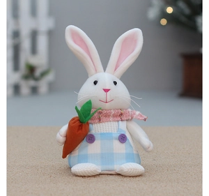Detailed view of plush Easter bunny wearing blue checkered overalls holding a carrot